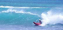 Kayak surfing off Long Caye, Belize